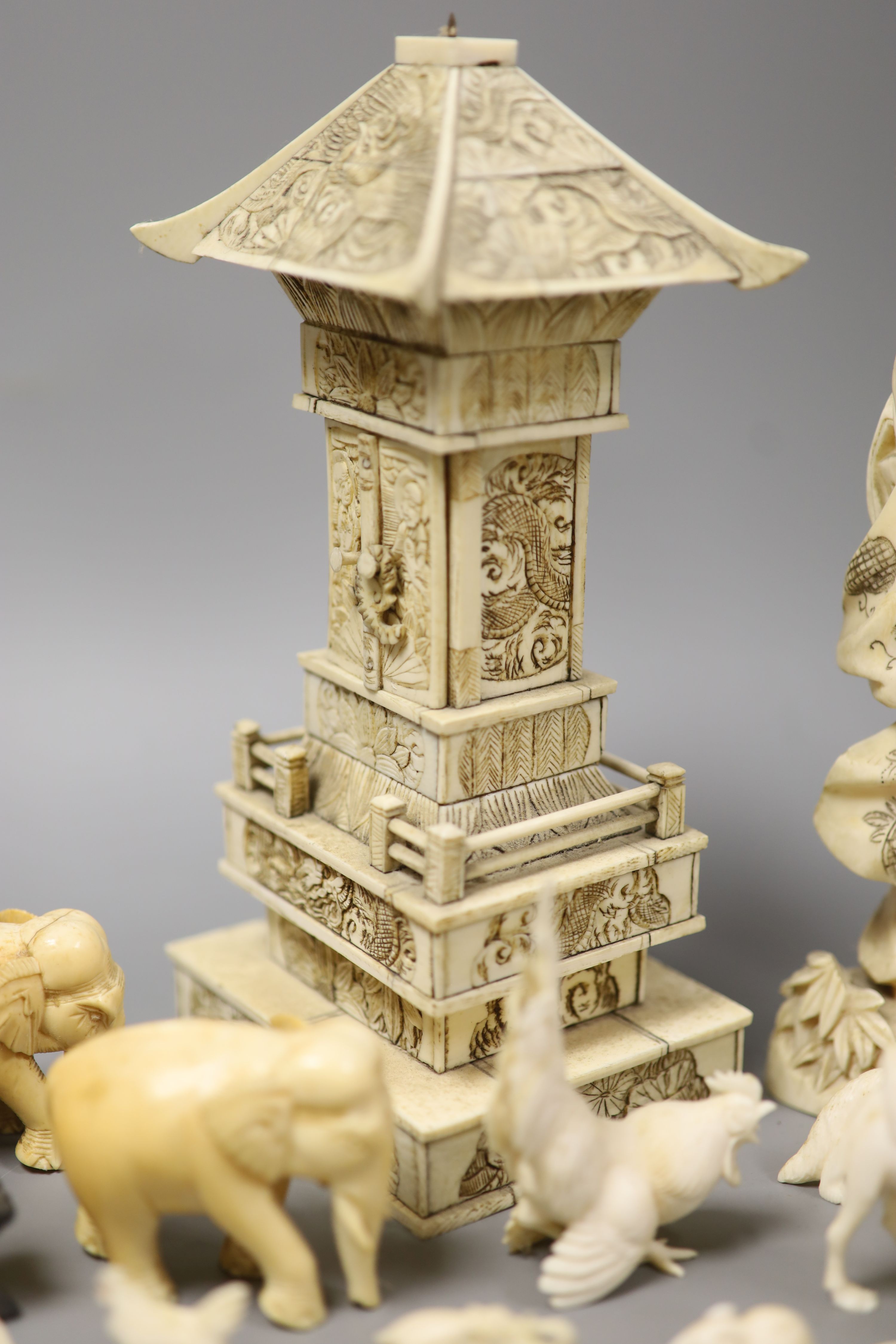 A Japanese Ivory model of a bijin, a similar model of a temple, various European Ivory models of animals and birds, an Indian Ivory figure et cetera, or late 19th or early 20th century